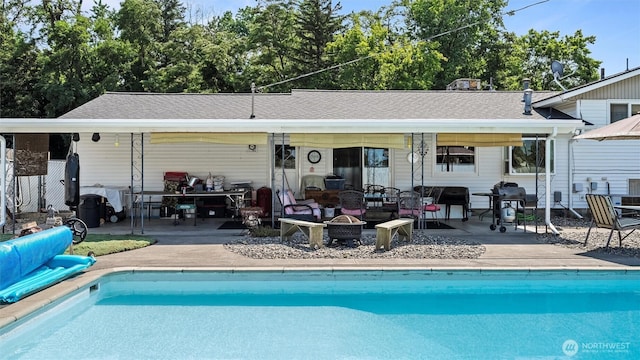 1314 S Division St, Walla Walla, WA 99362 - back of house with an outdoor pool, a patio area, an outdoor living space with a fire pit, and a shingled roof