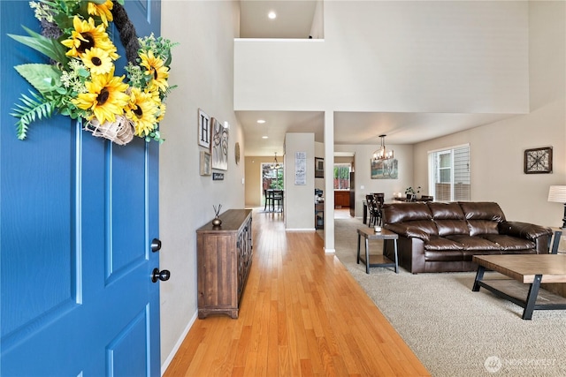12115 184th Ave E, Bonney Lake, WA 98391 - foyer entrance with light wood-style floors, a chandelier, and a high ceiling