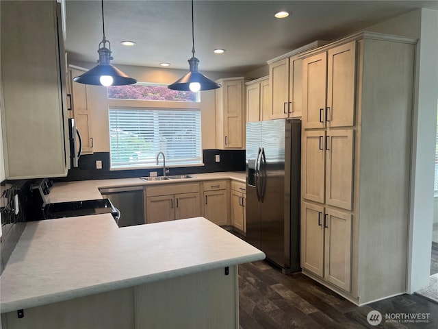 375 Union Ave SE Unit 97, Renton, WA 98059 - kitchen featuring appliances with stainless steel finishes, light countertops, recessed lighting, dark wood-style flooring, and a peninsula