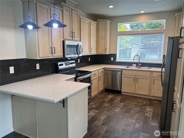 375 Union Ave SE Unit 97, Renton, WA 98059 - kitchen featuring appliances with stainless steel finishes, a peninsula, light countertops, recessed lighting, and backsplash