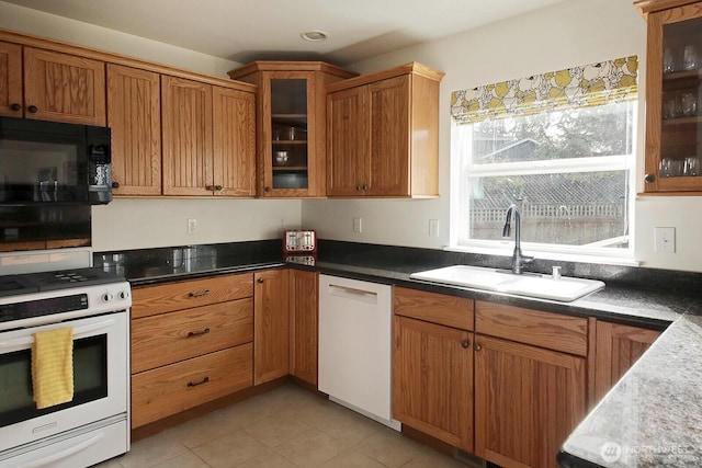 4876 Breezefair Rd, Freeland, WA 98249 - kitchen with white appliances, glass insert cabinets, brown cabinetry, light tile patterned floors, and recessed lighting