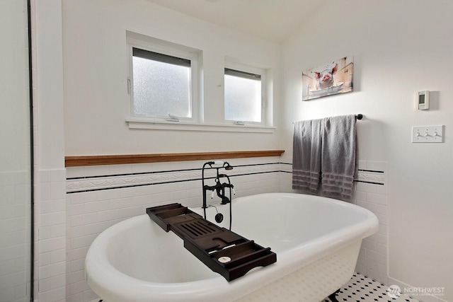 4876 Breezefair Rd, Freeland, WA 98249 - full bathroom with a soaking tub, wainscoting, and tile walls