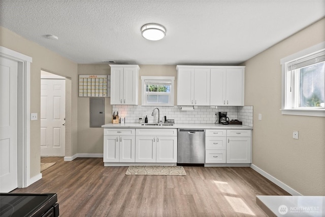 9413 356th Street Ct S, Roy, WA 98558 - kitchen featuring dishwasher, wood finished floors, tasteful backsplash, light countertops, and a textured ceiling