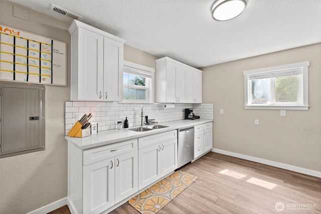 9413 356th Street Ct S, Roy, WA 98558 - kitchen featuring electric panel, plenty of natural light, decorative backsplash, light countertops, and a textured ceiling