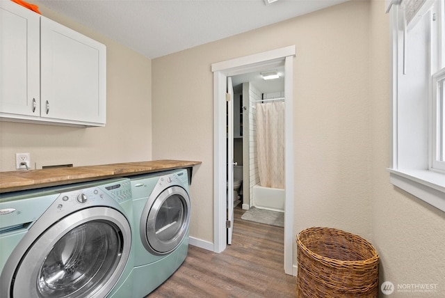 9413 356th Street Ct S, Roy, WA 98558 - laundry area featuring independent washer and dryer, cabinet space, wood finished floors, and plenty of natural light