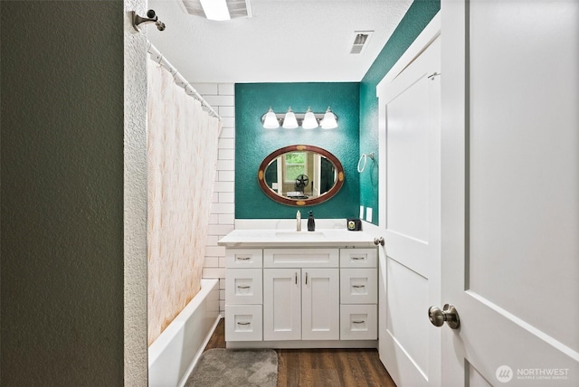 9413 356th Street Ct S, Roy, WA 98558 - bathroom with a textured wall, wood finished floors, vanity, and shower / bath combination with curtain