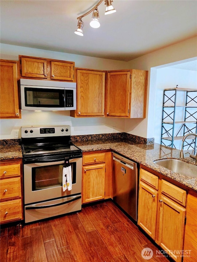12840 SE 40th Ct Unit B12, Bellevue, WA 98006 - kitchen with appliances with stainless steel finishes, dark wood-style flooring, dark stone countertops, and brown cabinetry