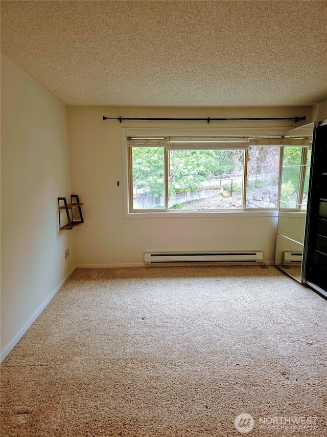 12840 SE 40th Ct Unit B12, Bellevue, WA 98006 - empty room with baseboard heating, a textured ceiling, carpet, and healthy amount of natural light