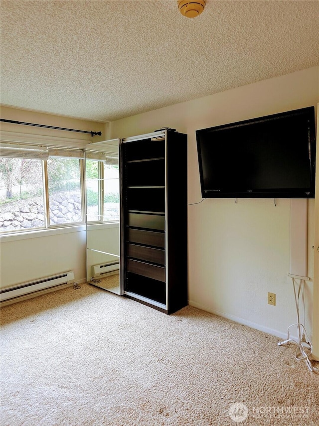 12840 SE 40th Ct Unit B12, Bellevue, WA 98006 - unfurnished bedroom featuring carpet, a baseboard radiator, and a textured ceiling