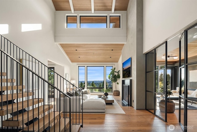 9001 NE 14th St, Clyde Hill, WA 98004 - foyer with a towering ceiling, hardwood / wood-style flooring, wooden ceiling, a fireplace, and stairs