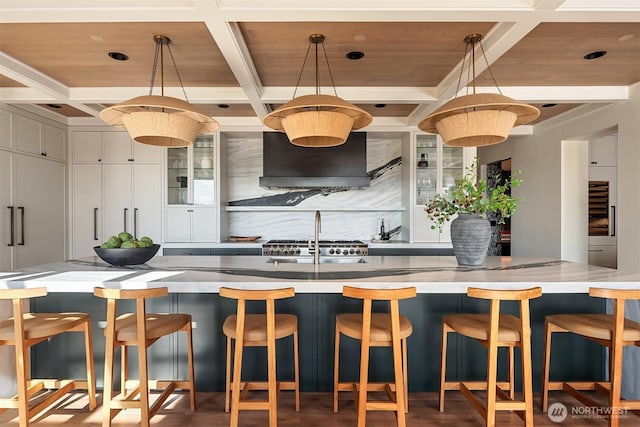 9001 NE 14th St, Clyde Hill, WA 98004 - kitchen with coffered ceiling, custom exhaust hood, backsplash, decorative light fixtures, and a wooden ceiling with exposed beams