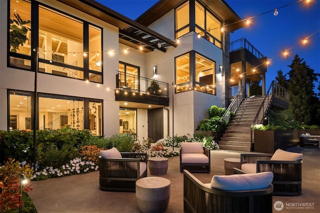 9001 NE 14th St, Clyde Hill, WA 98004 - patio at twilight with stairway, a patio area, and a balcony