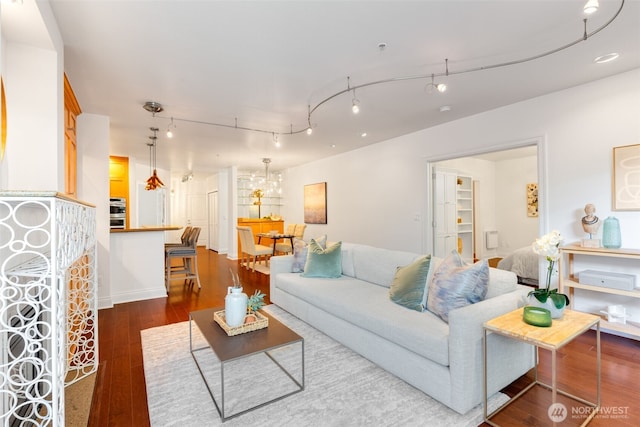 719 2nd Ave W Unit 101, Seattle, WA 98119 - living room featuring dark wood finished floors and a chandelier