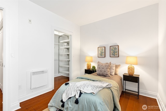 719 2nd Ave W Unit 101, Seattle, WA 98119 - bedroom featuring wood finished floors, a spacious closet, a closet, and heating unit