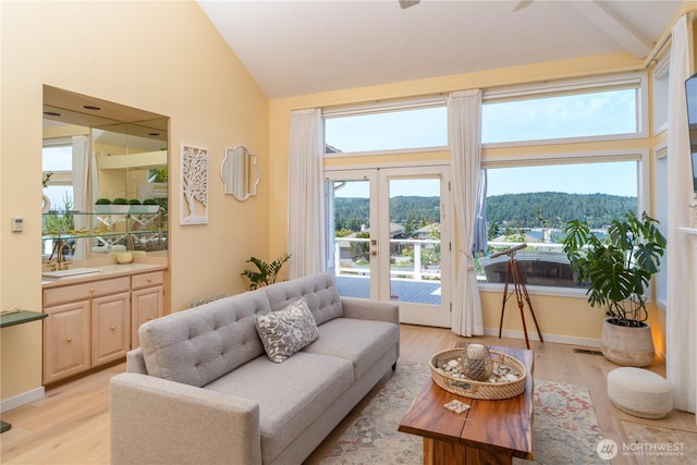95 Martingale Pl, Port Ludlow, WA 98365 - living area with light wood-style flooring, high vaulted ceiling, and french doors