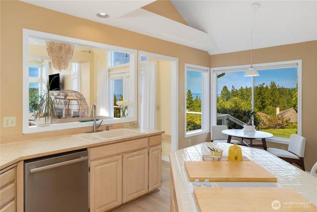 95 Martingale Pl, Port Ludlow, WA 98365 - kitchen with stainless steel dishwasher, light brown cabinets, lofted ceiling, light countertops, and pendant lighting