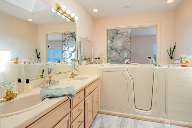 95 Martingale Pl, Port Ludlow, WA 98365 - full bath featuring double vanity, a bath, a skylight, and marble finish floors