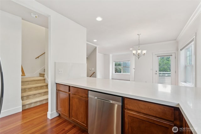 9503 Ashworth Ave N Unit B, Seattle, WA 98103 - kitchen featuring dishwasher, a peninsula, wood finished floors, brown cabinets, and light countertops