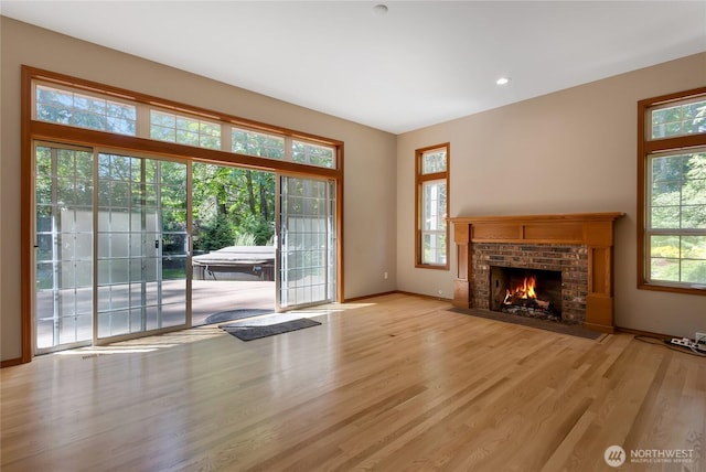 3941 16th Ln NE, Olympia, WA 98506 - unfurnished living room with wood finished floors and a fireplace