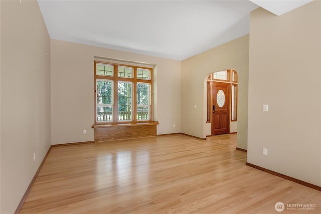 3941 16th Ln NE, Olympia, WA 98506 - empty room featuring arched walkways and light wood-style floors