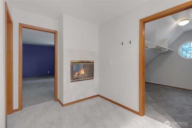 3941 16th Ln NE, Olympia, WA 98506 - unfurnished room with light carpet, a tiled fireplace, and vaulted ceiling