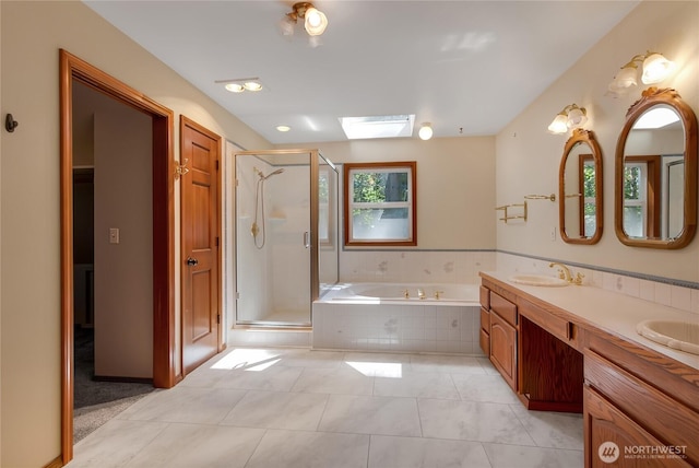 3941 16th Ln NE, Olympia, WA 98506 - bathroom with a bath, double vanity, a shower stall, tile patterned flooring, and a skylight