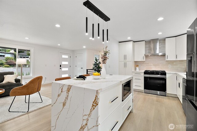 6347 121st Ave SE, Bellevue, WA 98006 - kitchen featuring wall chimney exhaust hood, stainless steel appliances, recessed lighting, light wood finished floors, and backsplash