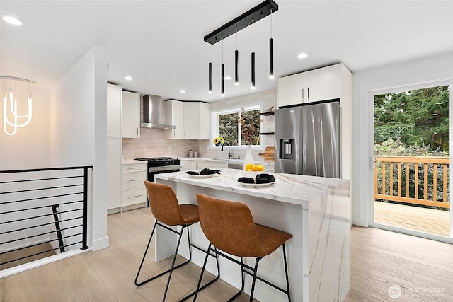 6347 121st Ave SE, Bellevue, WA 98006 - kitchen featuring appliances with stainless steel finishes, wall chimney exhaust hood, light wood finished floors, backsplash, and recessed lighting