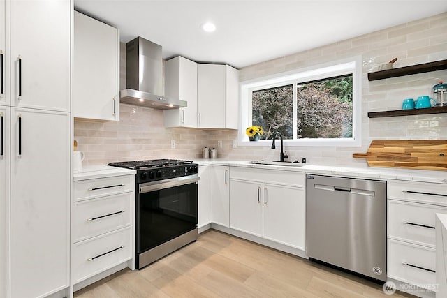 6347 121st Ave SE, Bellevue, WA 98006 - kitchen with dishwasher, gas range, wall chimney exhaust hood, light countertops, and recessed lighting