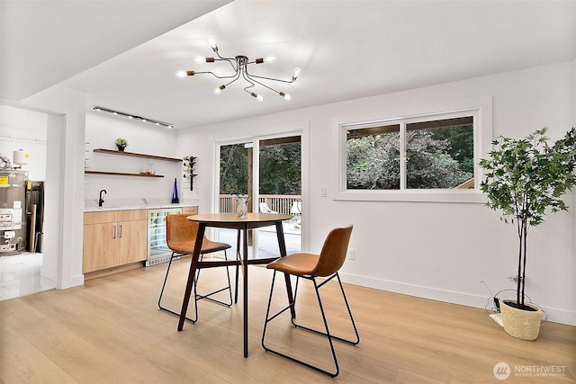 6347 121st Ave SE, Bellevue, WA 98006 - dining room featuring beverage cooler, light wood-style floors, wet bar, water heater, and a chandelier
