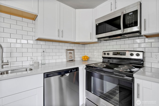 1815 S Cedar St, Tacoma, WA 98405 - kitchen with stainless steel appliances, light countertops, white cabinets, and backsplash