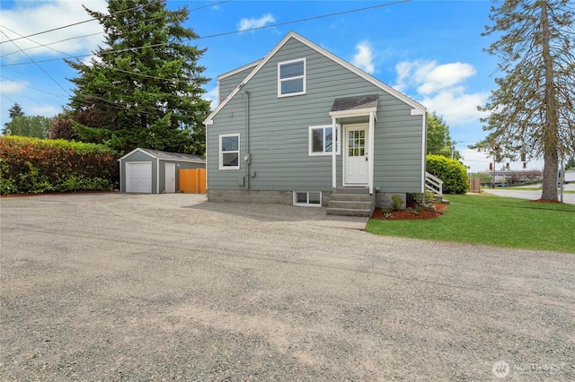 1815 S Cedar St, Tacoma, WA 98405 - rear view of property with entry steps, gravel driveway, an outbuilding, a garage, and a yard