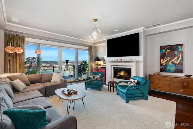 207 Broadway Unit 500, Tacoma, WA 98402 - living area featuring crown molding, a lit fireplace, dark wood-type flooring, and a tray ceiling