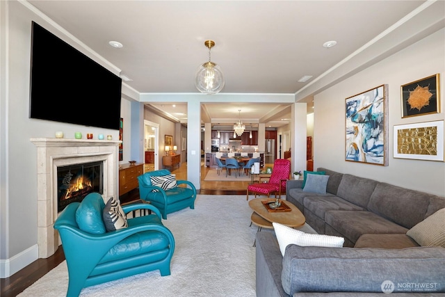 207 Broadway Unit 500, Tacoma, WA 98402 - living area featuring wood finished floors, a chandelier, a high end fireplace, and ornamental molding