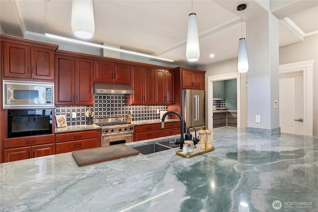 207 Broadway Unit 500, Tacoma, WA 98402 - kitchen with premium appliances, under cabinet range hood, backsplash, light stone countertops, and hanging light fixtures