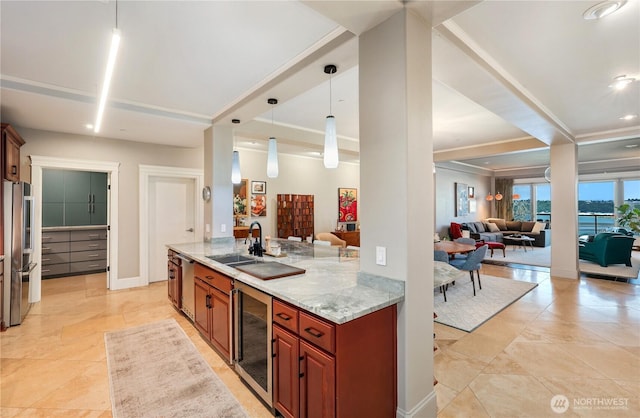207 Broadway Unit 500, Tacoma, WA 98402 - kitchen with stainless steel appliances, open floor plan, light stone counters, and beverage cooler