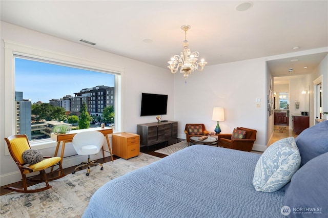 207 Broadway Unit 500, Tacoma, WA 98402 - bedroom with light wood-style floors and a chandelier