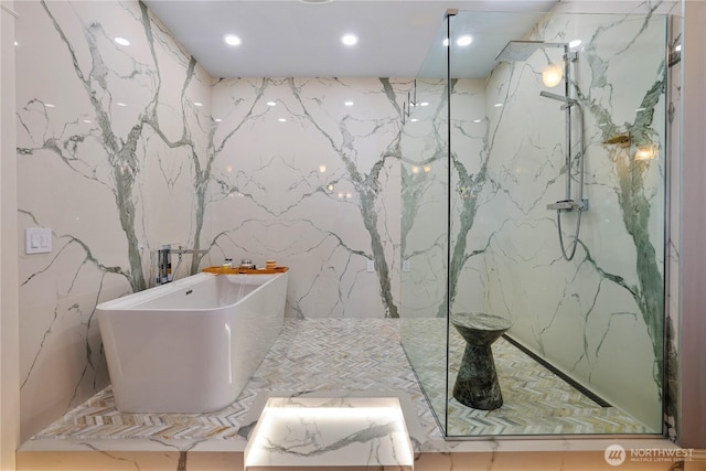 207 Broadway Unit 500, Tacoma, WA 98402 - bathroom with a marble finish shower, a freestanding bath, stone wall, and recessed lighting