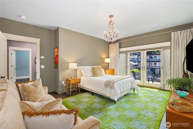 207 Broadway Unit 500, Tacoma, WA 98402 - bedroom with french doors, access to exterior, wood finished floors, and a chandelier