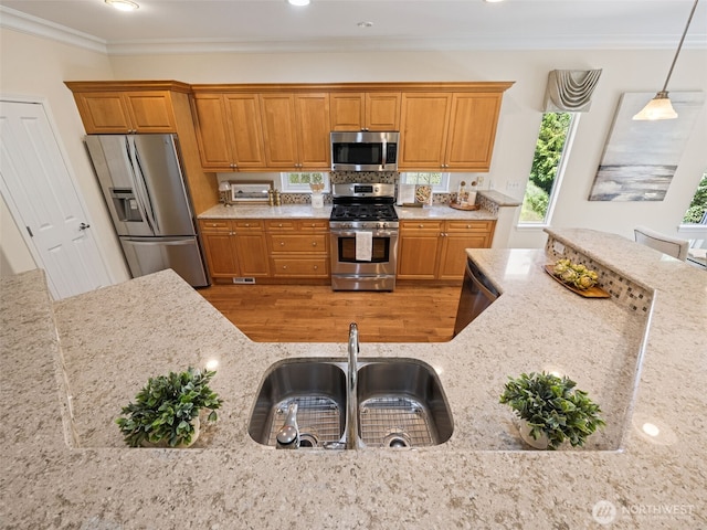 31867 48th Cir SW Unit 14A, Federal Way, WA 98023 - kitchen featuring stainless steel appliances, wood finished floors, brown cabinetry, light stone counters, and pendant lighting