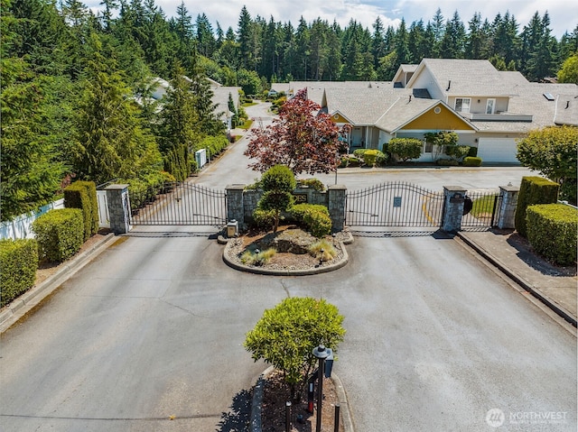 31867 48th Cir SW Unit 14A, Federal Way, WA 98023 - view of front of property with a gate, a view of trees, and curved driveway