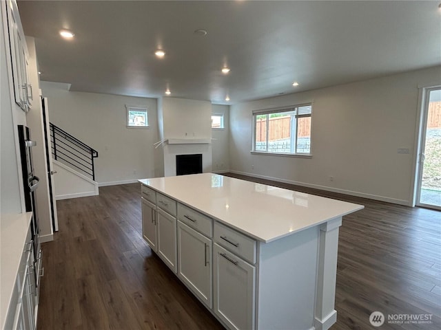 37568 30th Pl S Unit Lot38, Federal Way, WA 98003 - kitchen with open floor plan, dark wood-style flooring, a center island, a fireplace, and light countertops