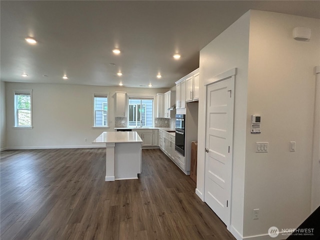 37568 30th Pl S Unit Lot38, Federal Way, WA 98003 - kitchen featuring healthy amount of natural light, white cabinetry, dark wood-style flooring, a center island, and recessed lighting