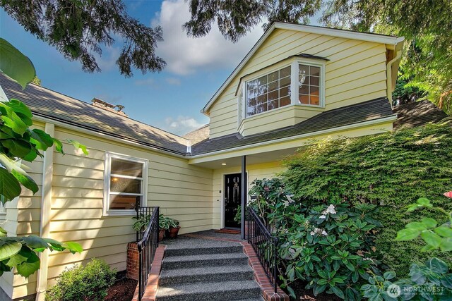 4412 43rd Ave NE, Seattle, WA 98105 - view of front facade featuring roof with shingles and covered porch