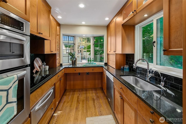 4412 43rd Ave NE, Seattle, WA 98105 - kitchen featuring stainless steel appliances, a warming drawer, light wood-type flooring, brown cabinetry, and recessed lighting