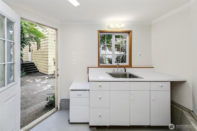 4412 43rd Ave NE, Seattle, WA 98105 - kitchen with light countertops, white cabinetry, and concrete floors