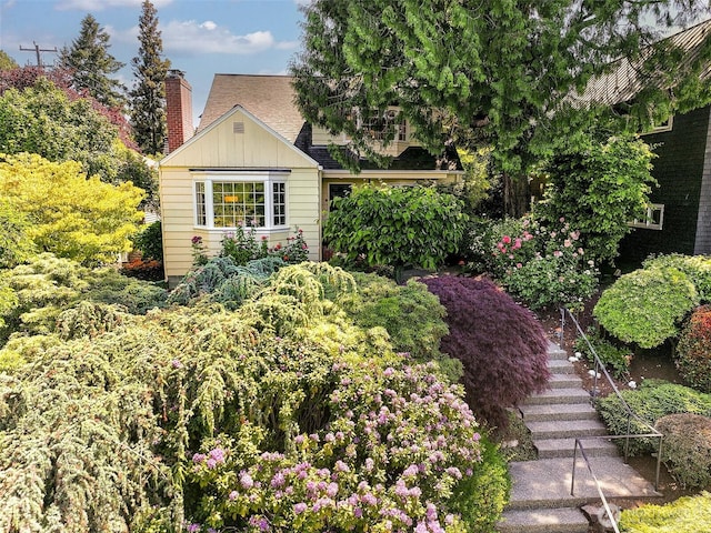 4412 43rd Ave NE, Seattle, WA 98105 - view of front facade with board and batten siding, stairs, and a chimney