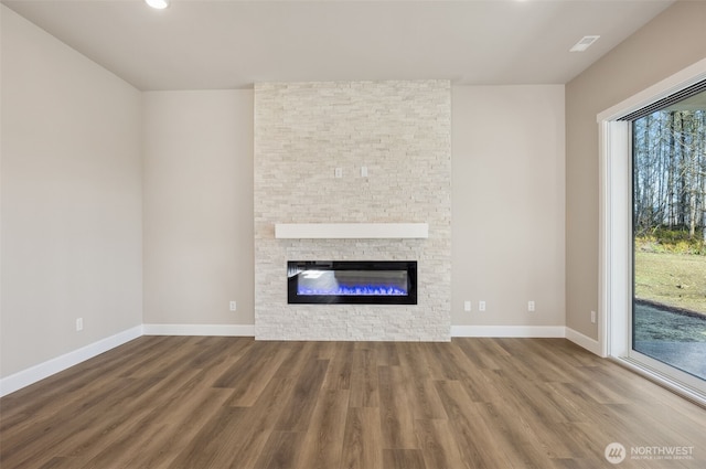 10630 134th Dr NE Unit 112, Lake Stevens, WA 98258 - unfurnished living room featuring wood finished floors, healthy amount of natural light, a stone fireplace, and recessed lighting
