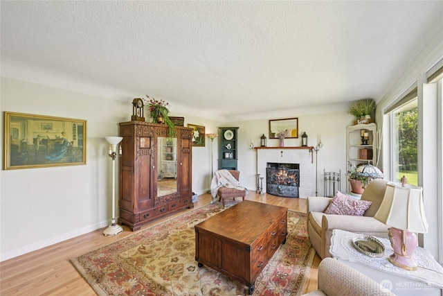 910 Crestline Dr, Longview, WA 98632 - living room featuring a brick fireplace, wood finished floors, and a textured ceiling