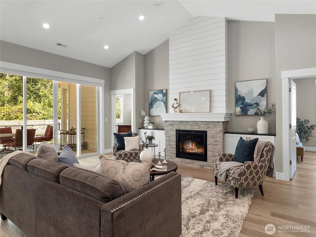 13809 119th Street Ct NW, Gig Harbor, WA 98329 - living area featuring high vaulted ceiling, light wood-type flooring, a stone fireplace, and recessed lighting